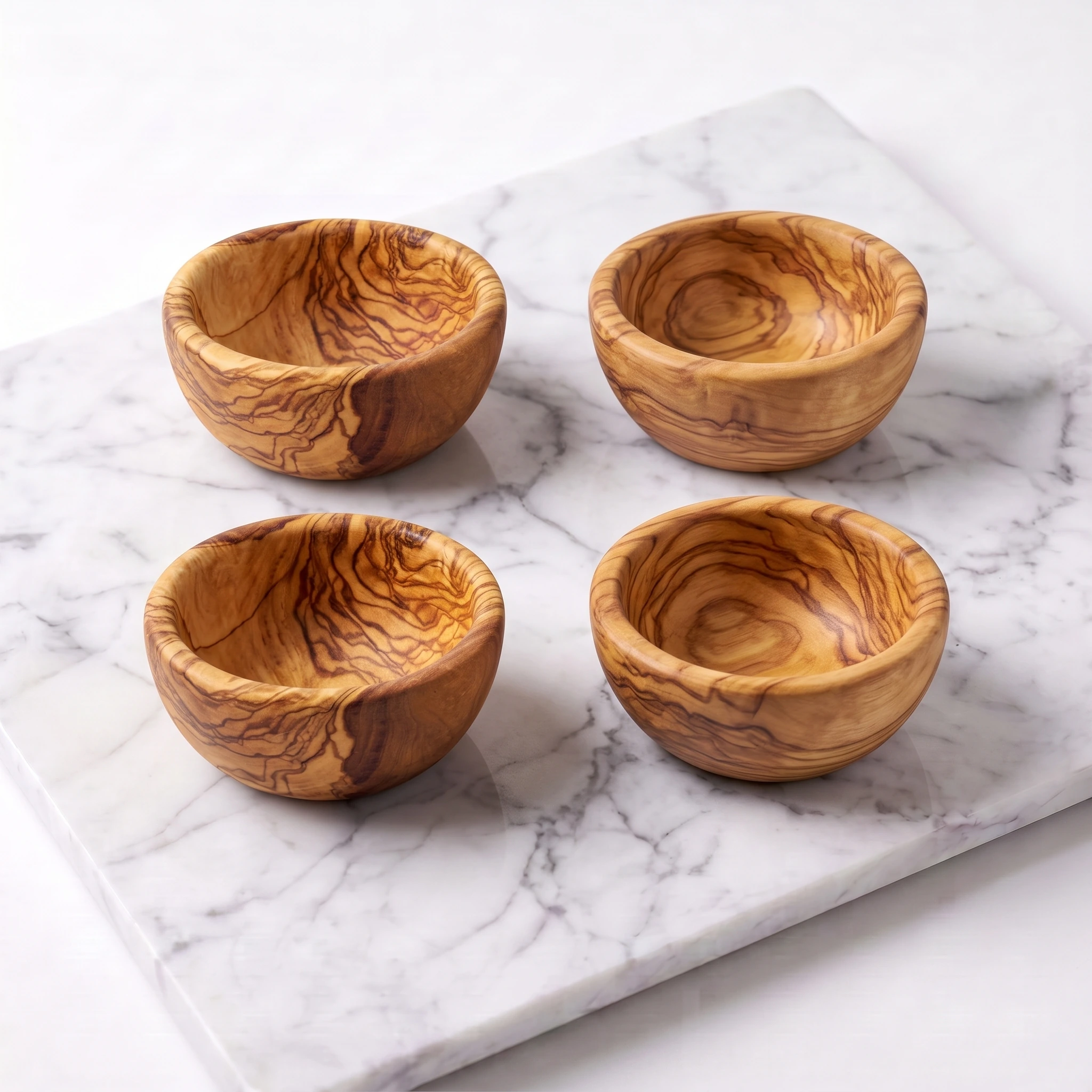 Set of 4 mini olive wood bowls, studio view