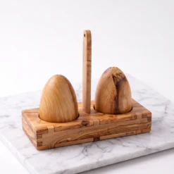 Olive wood salt and pepper shakers placed on their matching stand