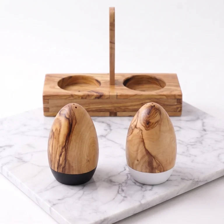 Olive wood salt and pepper shakers in front of their matching stand