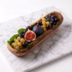 Olive wood fruit bowl filled with figs and grapes