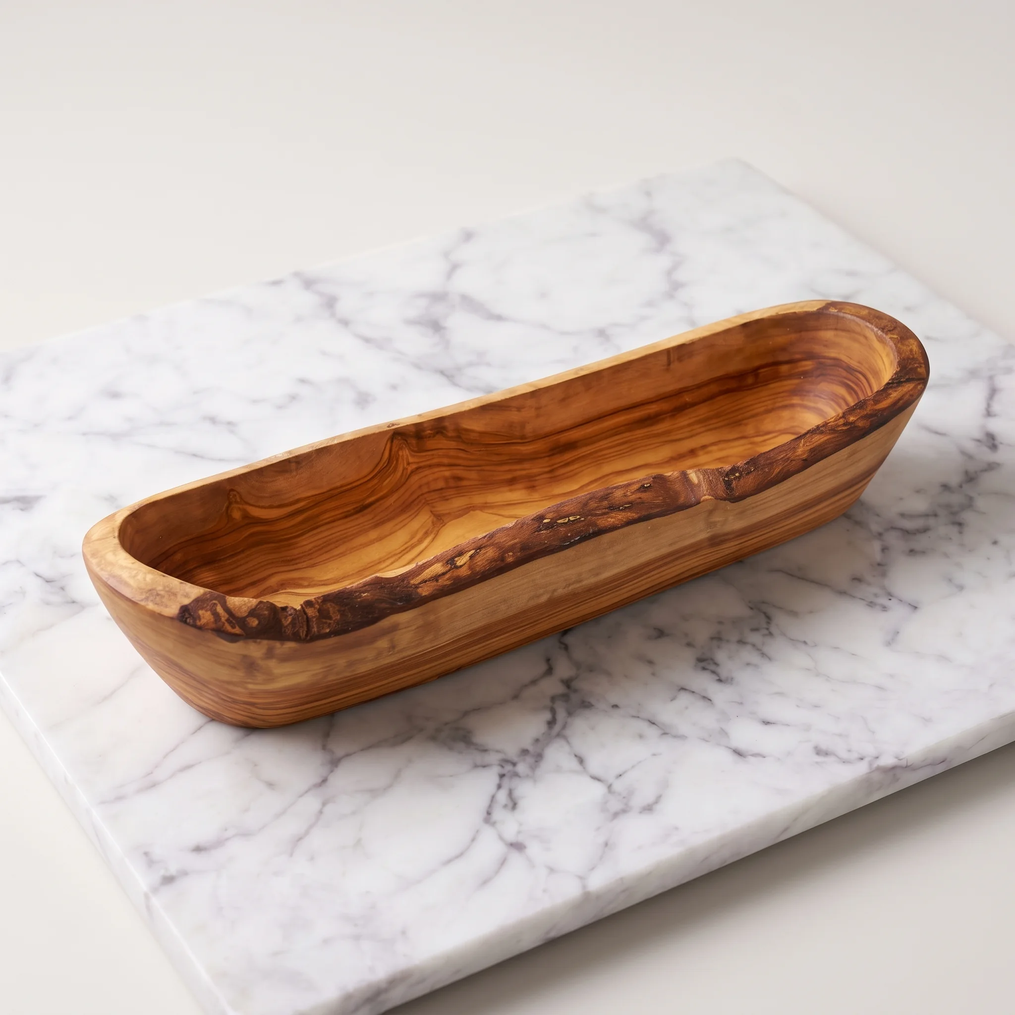 Empty olive wood fruit bowl and bread basket on light marble