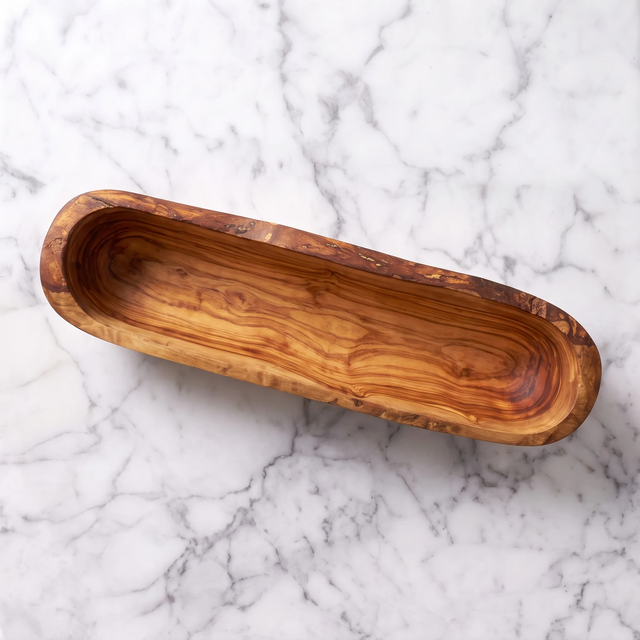 High-angle view of an empty elongated olive wood bowl