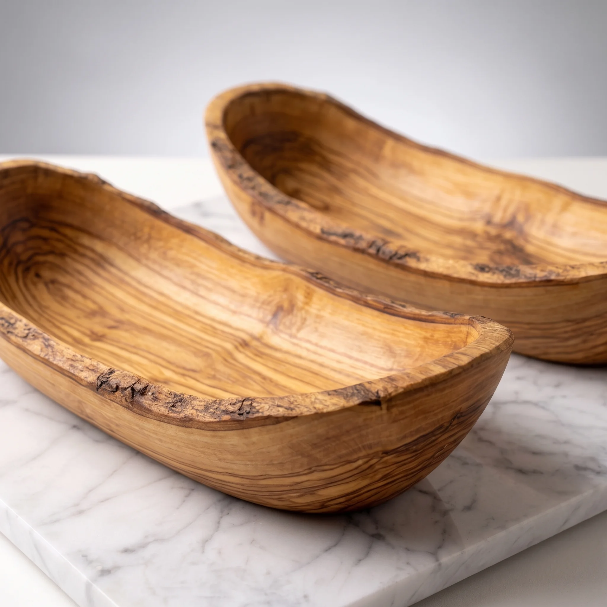 Close-up of the natural grain across two olive wood bowls