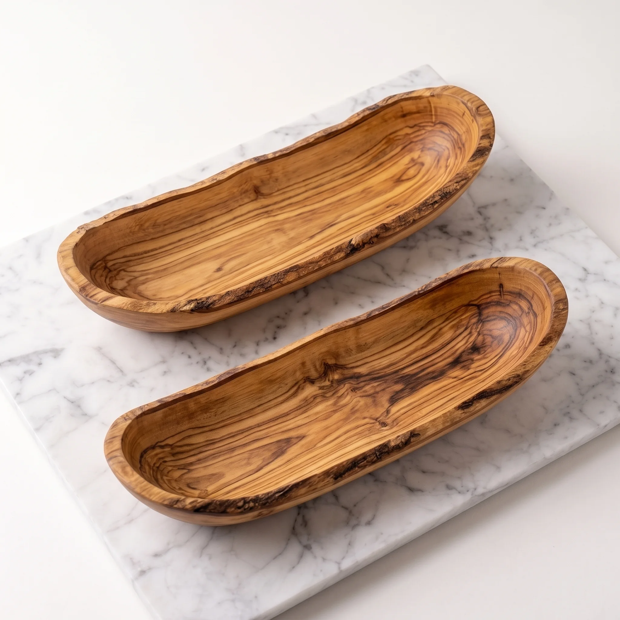 High-angle view of two empty elongated olive wood bowls