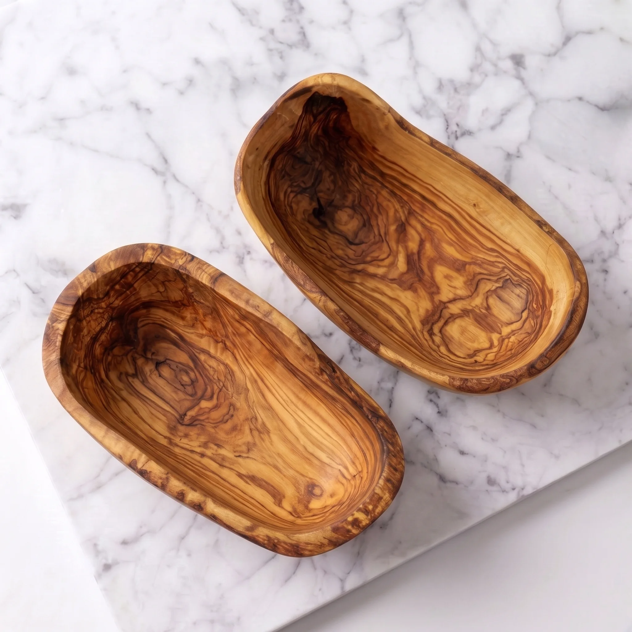 Overhead view of two empty olive wood tapas bowls