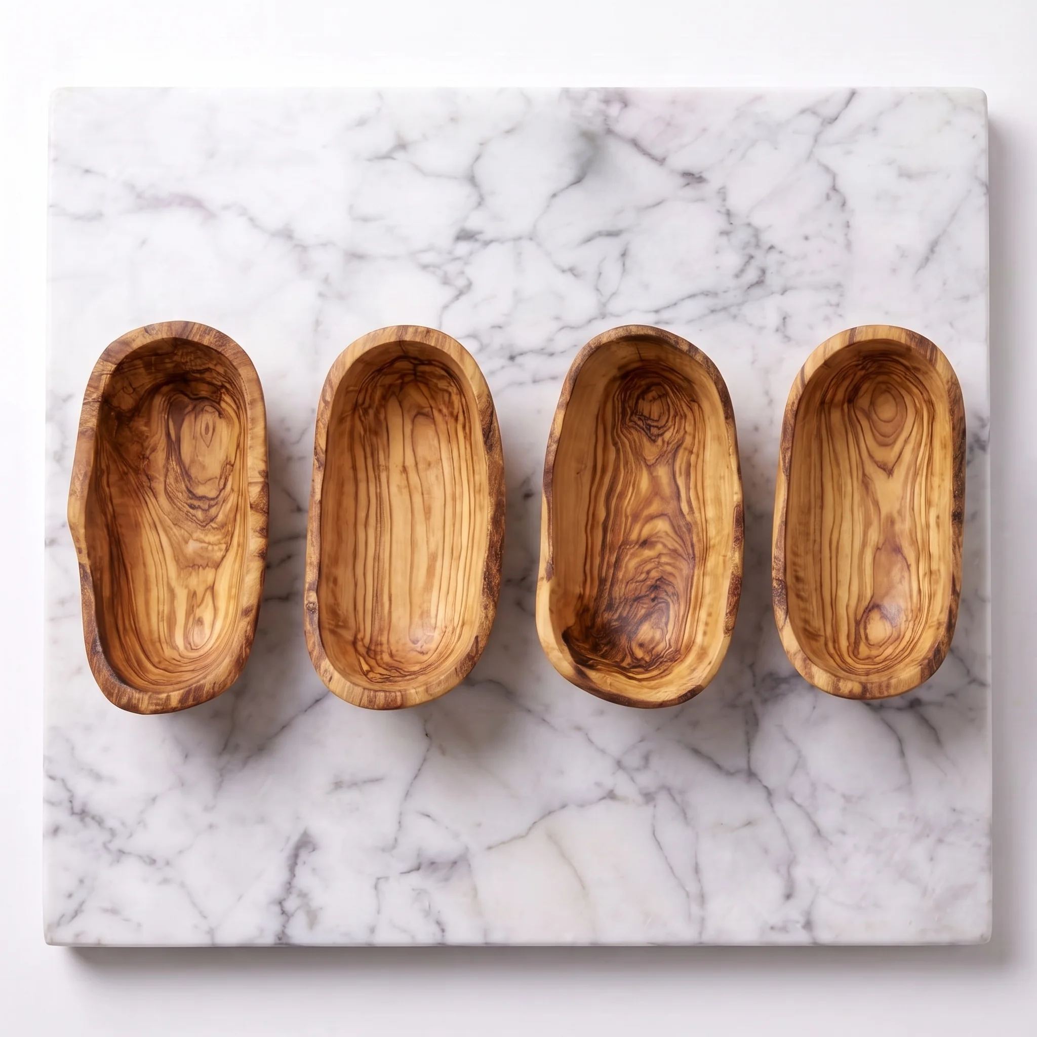 Top view of four empty olive wood tapas bowls
