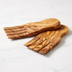 Close-up of the grain on a pair of olive wood salad hands