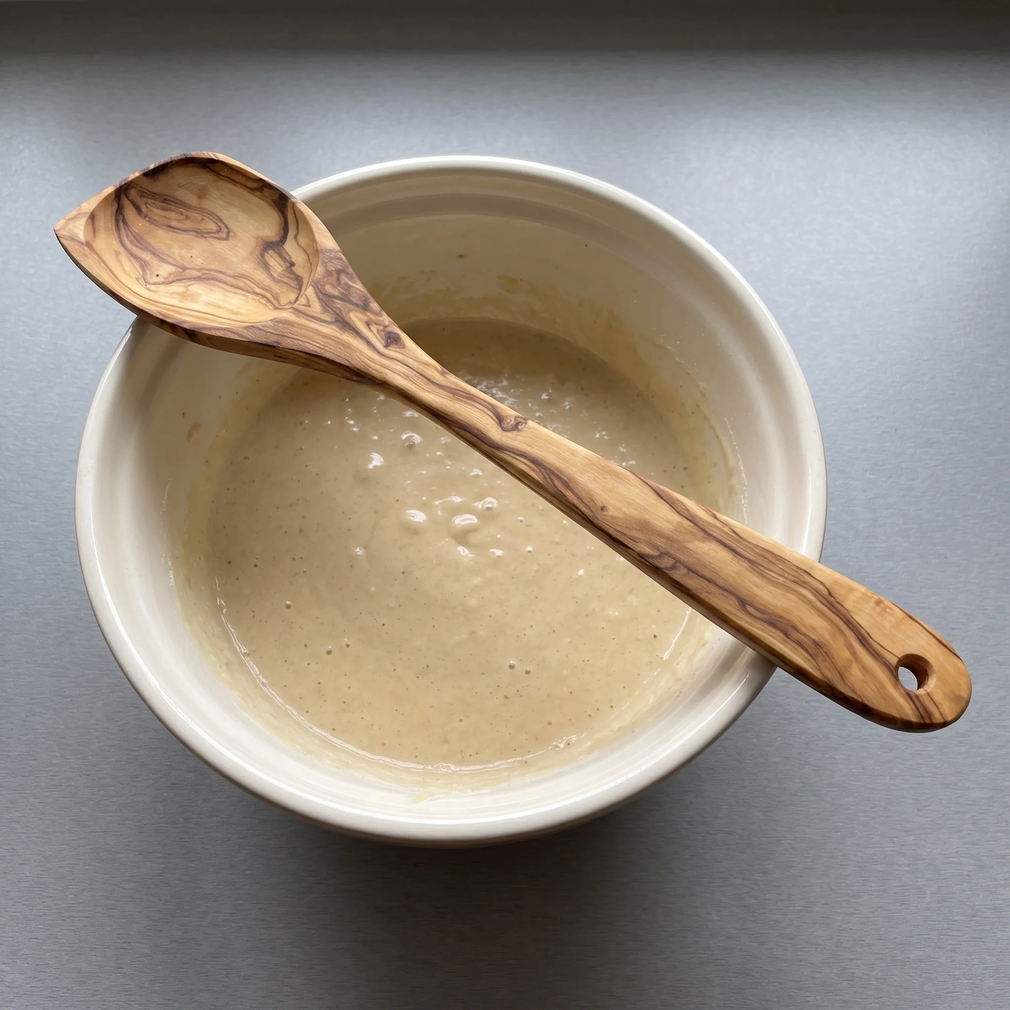Olive wood mixing spoon with a mixing bowl