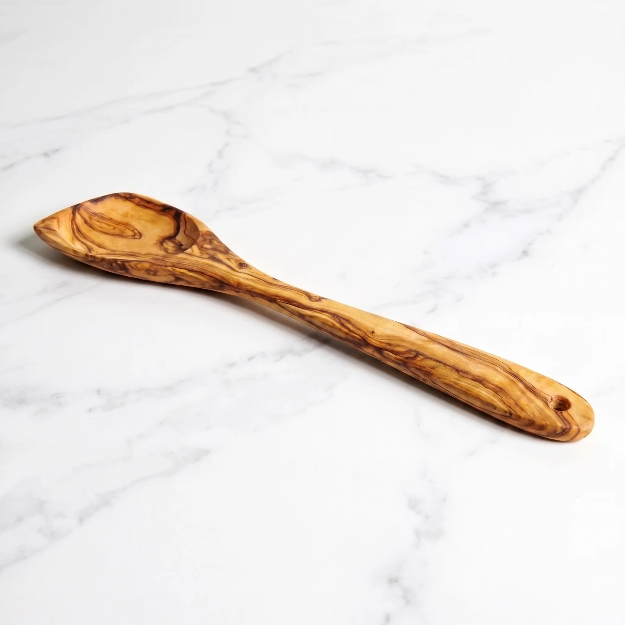 Low profile of an olive wood mixing spoon