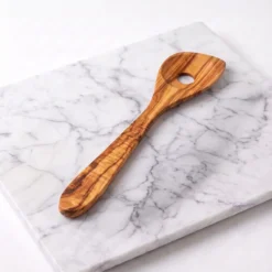 Slotted olive wood risotto spoon, three-quarter studio view