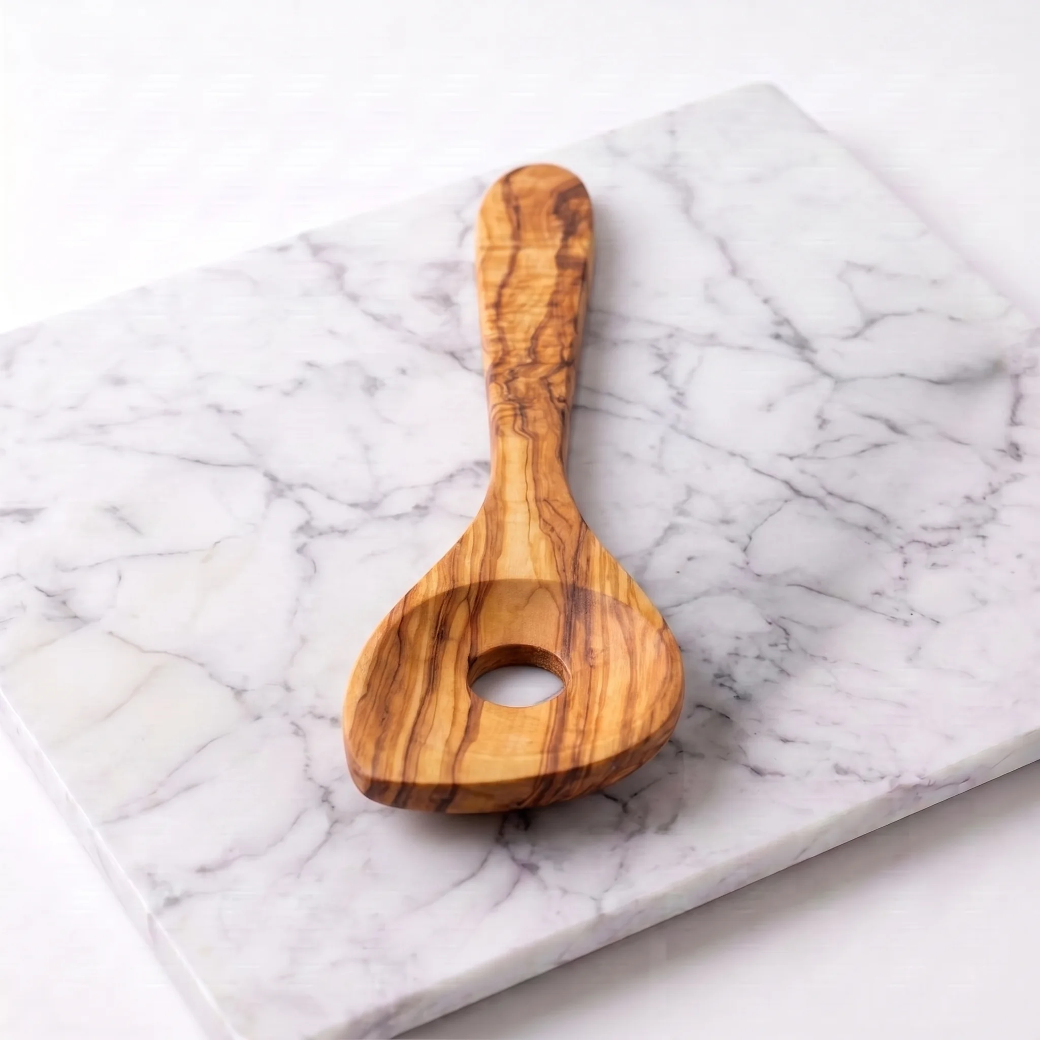 Slotted olive wood risotto spoon, front studio view
