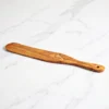 Olive wood spatula on white marble