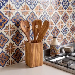 Three utensils in their holder in a kitchen setting