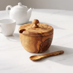 Boîte à sucre en bois d’olivier fermée près d’une tasse et d’une théière